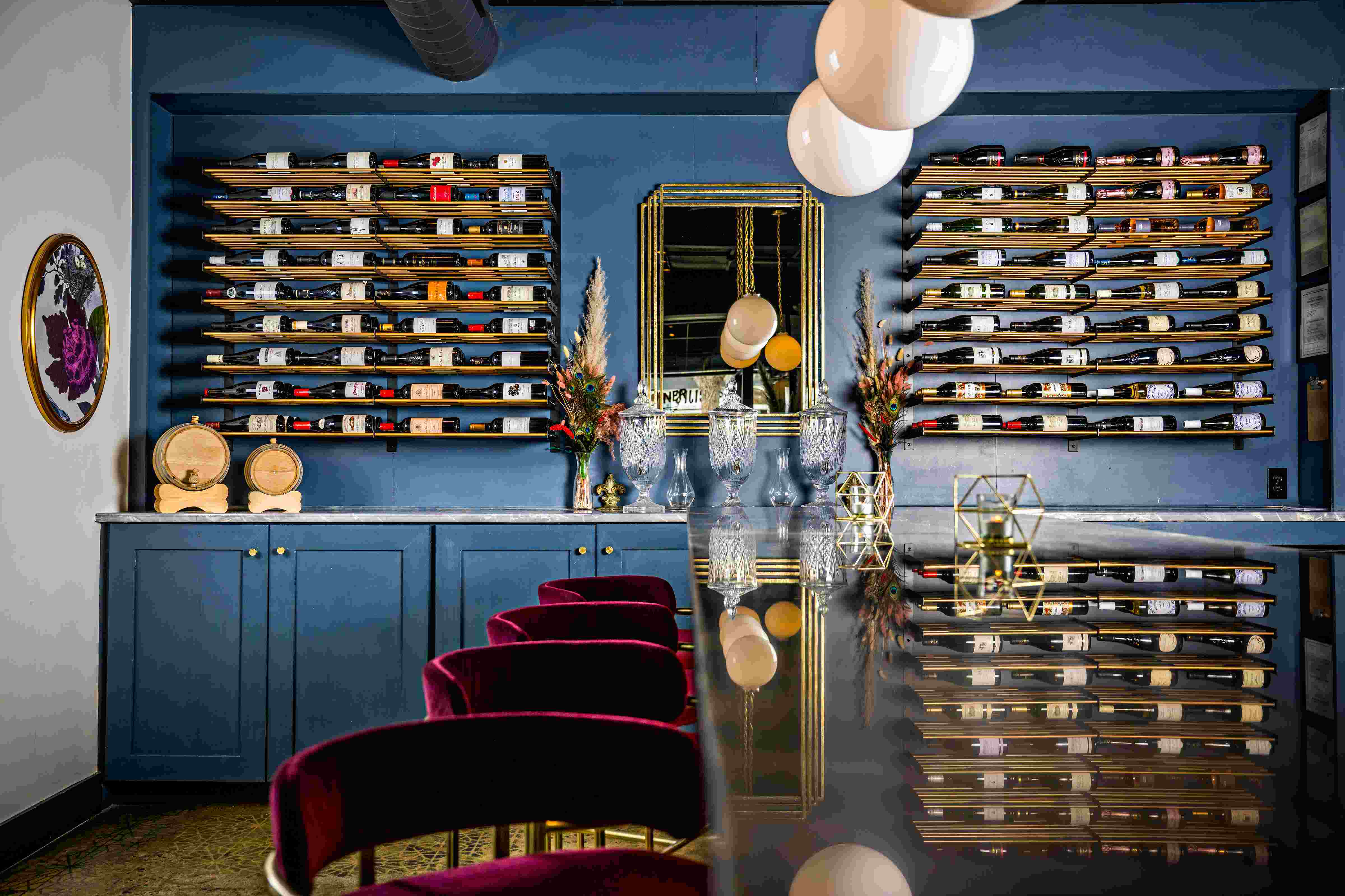 Photo: Jonathan Phillips Photography Kitchen wine display with brass-rod racking over marble Β· Photo: Jonathan Phillips Photography