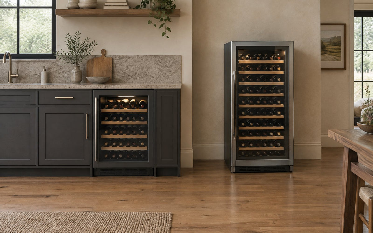A built-in wine refrigerator flush with kitchen cabinetry beside a freestanding wine refrigerator standing alone.