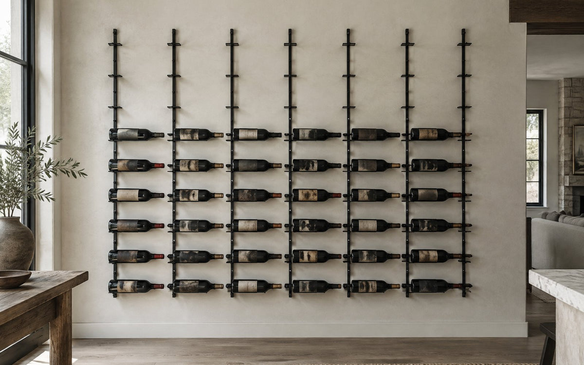 Wall of metal label-forward wine racks partially filled with bottles, showing row spacing and layout.