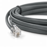 Illustration of a clear RJ9 plug on a flat grey communication cable