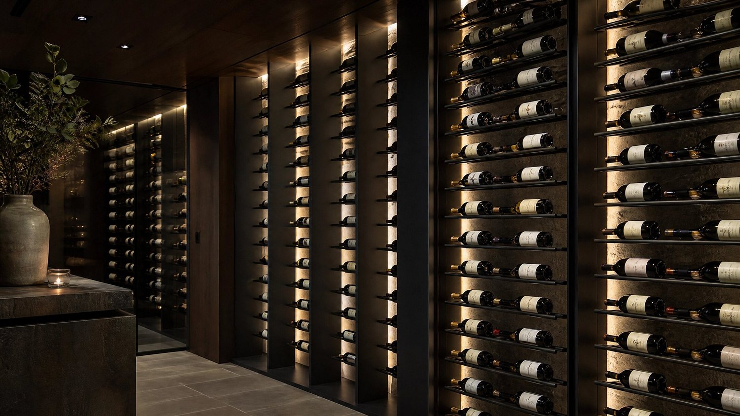 Backlit stone wine room with floor-to-ceiling metal racks